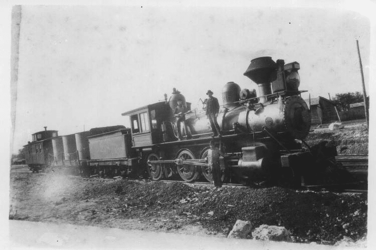 A historical photo of an early steam locomotive in Texas.
