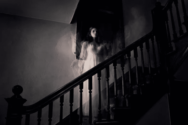 A lone, spooky road stretching into a dark, foggy landscape in Texas.