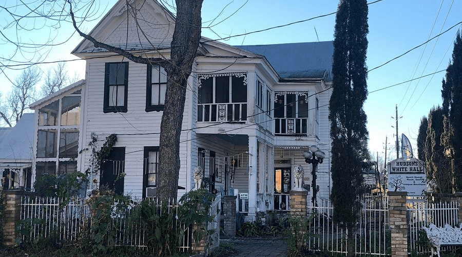 A quaint, old-fashioned town street at dusk, looking eerie.